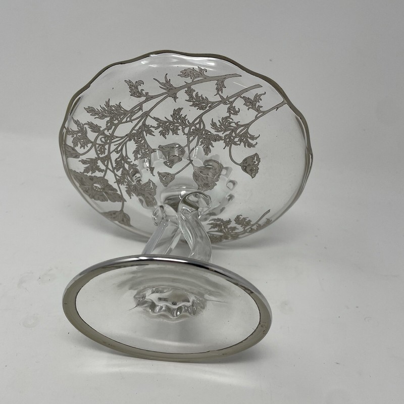 Clear glass pedestal stand with silver trim and silver flower accents gallery
