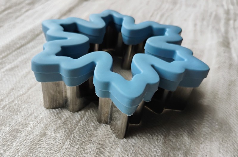 Two Wilton comfort-grip cookie cutters, blue snowflake and green Christmas tree. gallery