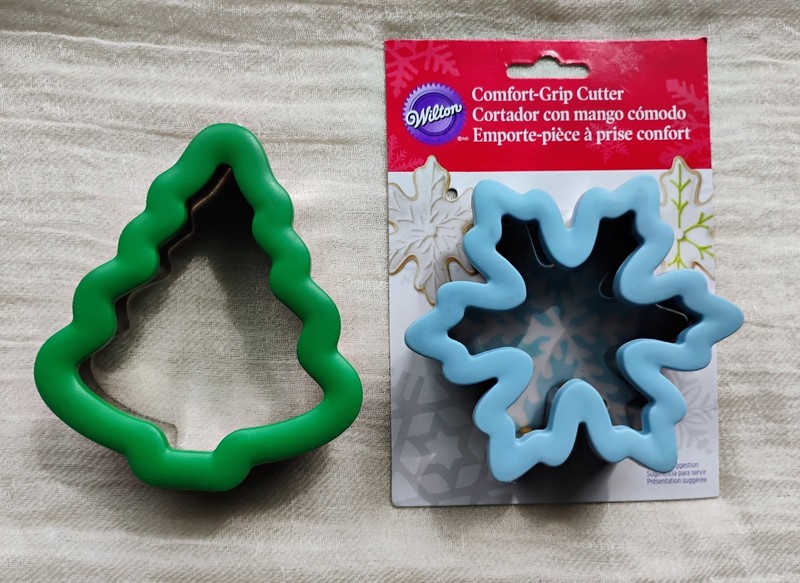 Two Wilton comfort-grip cookie cutters, blue snowflake and green Christmas tree. gallery