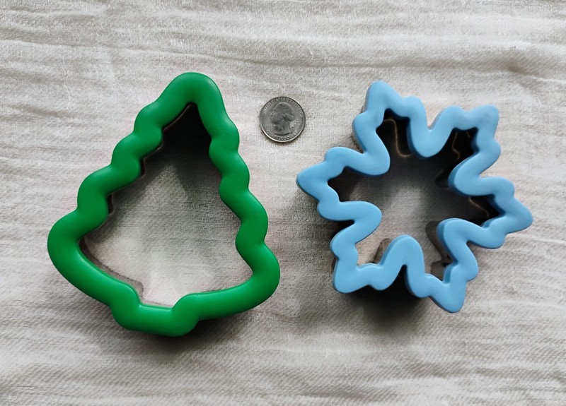 Two Wilton comfort-grip cookie cutters, blue snowflake and green Christmas tree. gallery