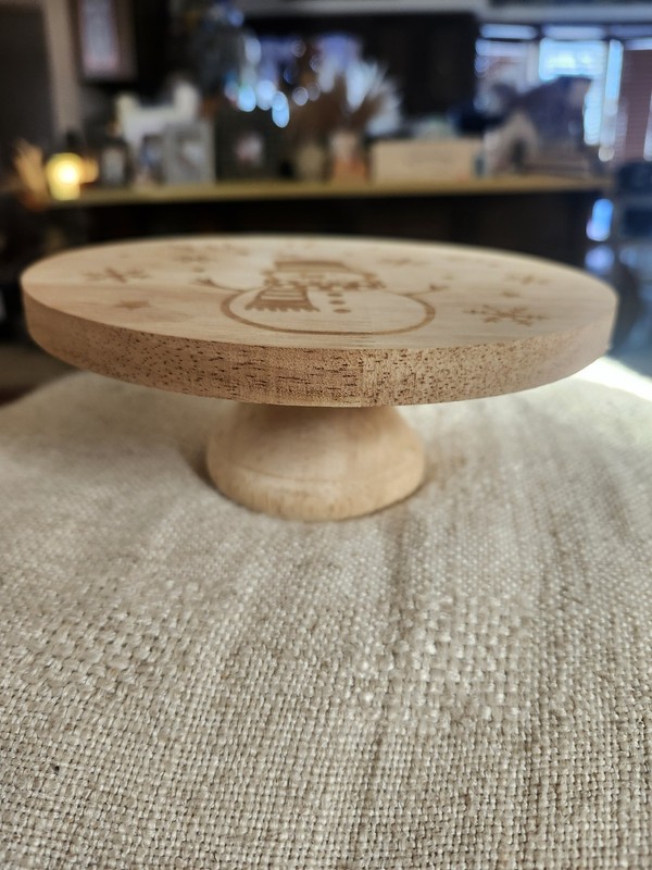 7 Inch Wooden Cake Stand With The Phrase "Let It Snow" With Snowman And Flakes gallery
